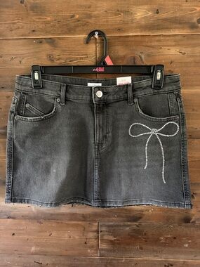 Millie Bobby Brown Black Denim Mini Skirt with rhinestone Bow Detail